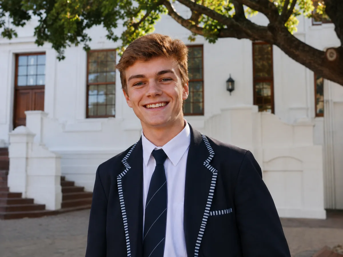 Smiling student outside a Stellenbosch University building